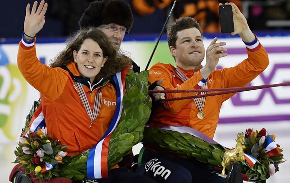 Allround winner Sven Kramer of the Netherlands, right, and Ireen Wuest of the Netherlands are on a victory round in a horse carriage at European Speed Skating Championships at the Thialf ice rink in H ...