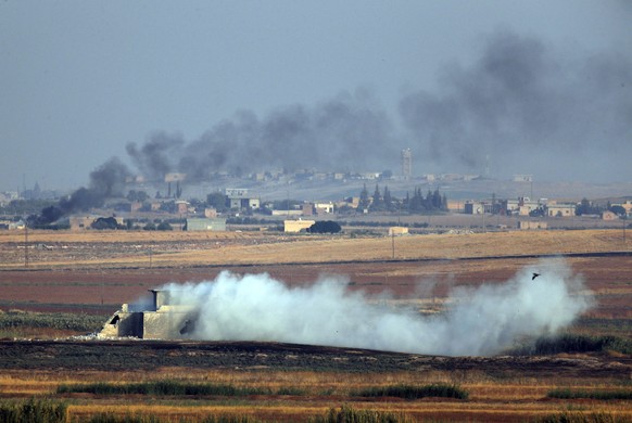 In this photo taken from the Turkish side of the border between Turkey and Syria, in Akcakale, Sanliurfa province, southeastern Turkey, smoke billows from targets inside Syria during bombardment by Tu ...