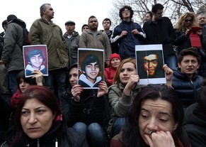 People holding images of the dead teenager as they gather to protest the death of Berkin Elvan, a Turkish teenager who was in a coma since being hit on the head by a tear gas canister fired by police during the last summer's anti-government protests, in Ankara, Turkey, Tuesday, March 11, 2014. The 15-year old Berkin Elvan’s death in an Istanbul hospital _ nine months after he fell into a coma _ looked likely to spark new protests in Turkey. Elvan, who turned 15 in January was caught up in the protests on his way to a shop to buy bread.(AP Photo/Burhan Ozbilici)