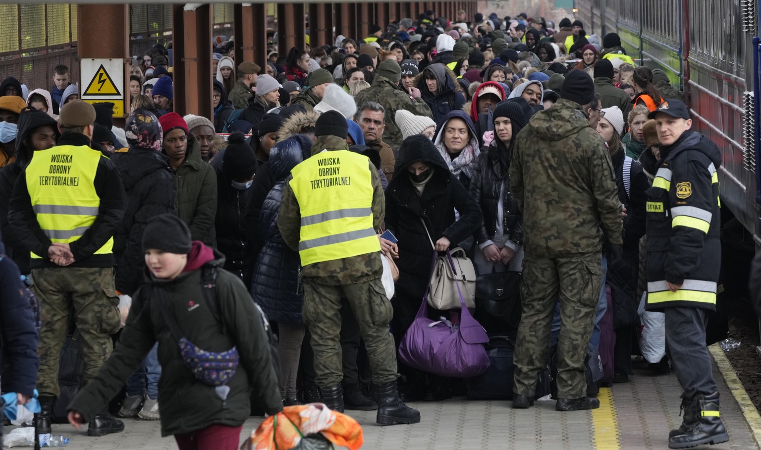 FILE - Refugees from Ukraine arrive at the railway station in Przemysl, Poland, Feb. 27, 2022. Nearly a year has passed since the Feb. 24, 2022, invasion sent millions of people fleeing across Ukraine ...