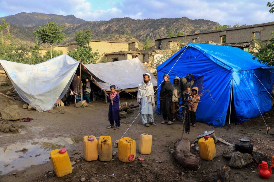 epa10028874 Afghans sit outside the temporary shelter after an earthquake in Gayan village in Paktia province, Afghanistan, 23 June 2022. More than 1,000 people were killed and over 1,500 others injur ...