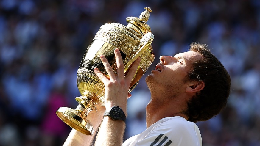 epa07274366 (FILE) - Andy Murray of Britain kisses the championship trophy after defeating Novak Djokovic of Serbia in the men&#039;s final for the Wimbledon Championships at the All England Lawn Tenn ...