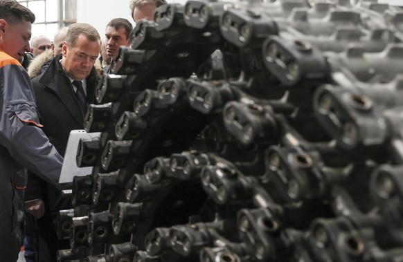 Russian Security Council Deputy Chairman and the head of the United Russia party Dmitry Medvedev, second left, visits the Omsk Transport Engineering Plant (JSC Omsktransmash) in Omsk, Russia, Thursday ...