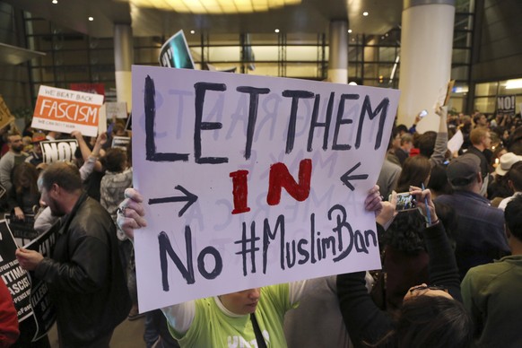 People opposed to President Donald Trump&#039;s executive order barring entry to the U.S. by Muslims from certain countries demonstrate at the Tom Bradley International Terminal at Los Angeles Interna ...