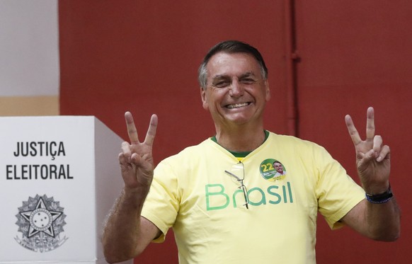 Brazilian President Jair Bolsonaro, who is running for another term, makes the victory sign after voting in a run-off presidential election in Rio de Janeiro, Brazil, Sunday, Oct. 30, 2022. (AP Photo/ ...
