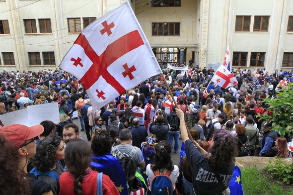 Demonstrators wave Georgian national flags during an opposition protest against the foreign influence bill at the Parliamentary building in Tbilisi, Georgia, Tuesday, May 28, 2024. (AP Photo/Shakh Aiv ...
