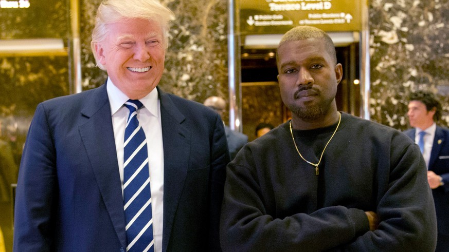 FILE - In this Dec. 13, 2016, file photo, then-President-elect Donald Trump and Kanye West pose for a picture in the lobby of Trump Tower in New York. Trump is tweeting his thanks to rap superstar Kan ...