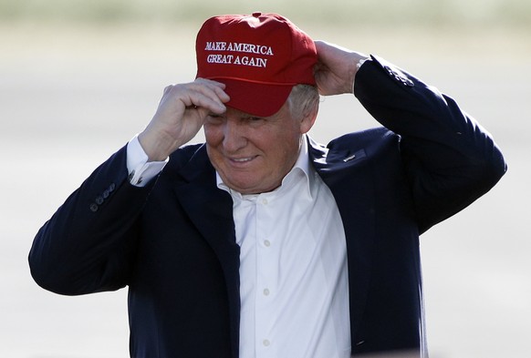 FILE - In this June 1, 2016, file photo, Republican presidential candidate Donald Trump wears his "Make America Great Again" hat at a rally in Sacramento, Calif. Hats with the now popular sl ...