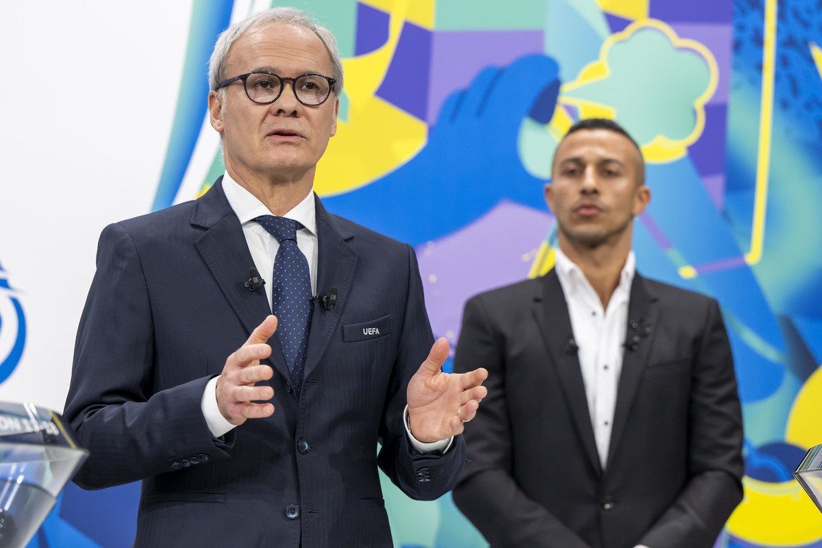 epa11865752 UEFA Deputy General Secretary Giorgio Marchetti (L) and two-time UEFA Champions League winner Thiago Alcantara during the UEFA Champions League knockout phase play-off draw at the UEFA hea ...