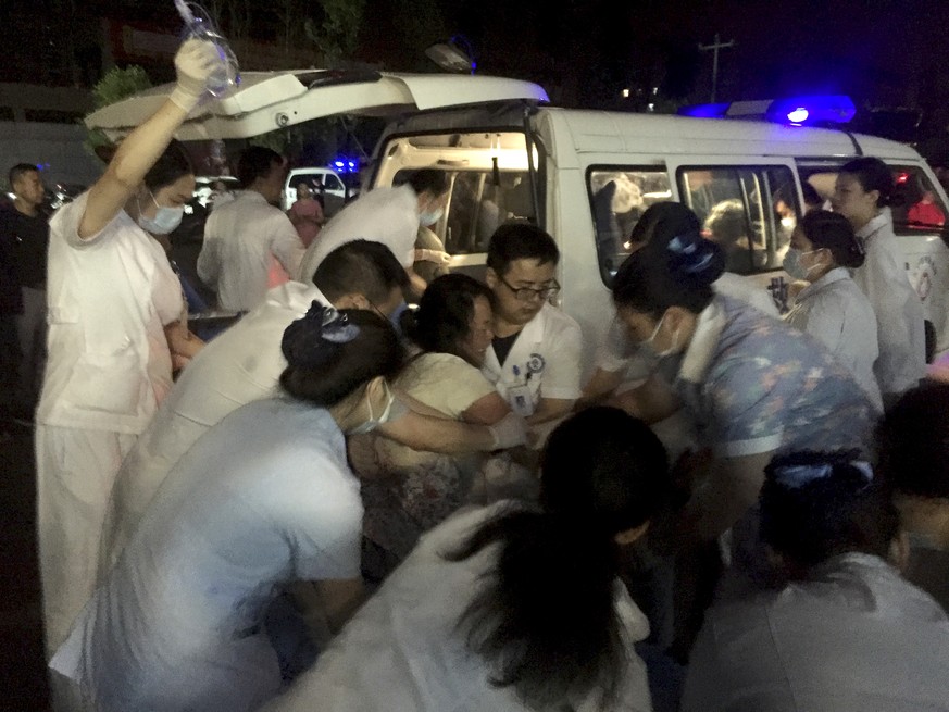 In this photo released by Xinhua News Agency, medical staff tend to a wounded at a local hospital in the aftermath of an earthquake in Changning County of Yibin City, southwest China&#039;s Sichuan Pr ...