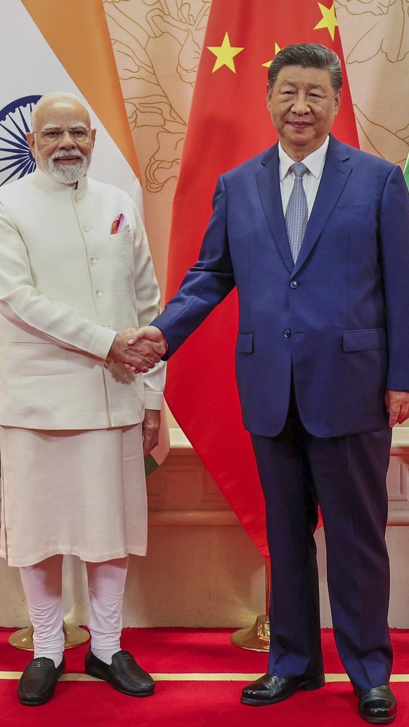 In this photo provided by Indian Prime Minister&#039;s Office, Indian Prime Minister Narendra Modi, left, and Chinese President Xi Jinping shake hand before their meeting on the sidelines of the Shang ...
