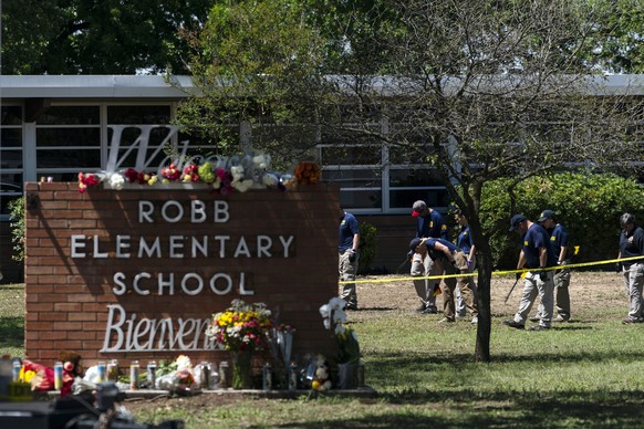 FILE - Investigators search for evidences outside Robb Elementary School in Uvalde, Texas, May 25, 2022, after an 18-year-old gunman killed 19 students and two teachers. The district���s superintenden ...