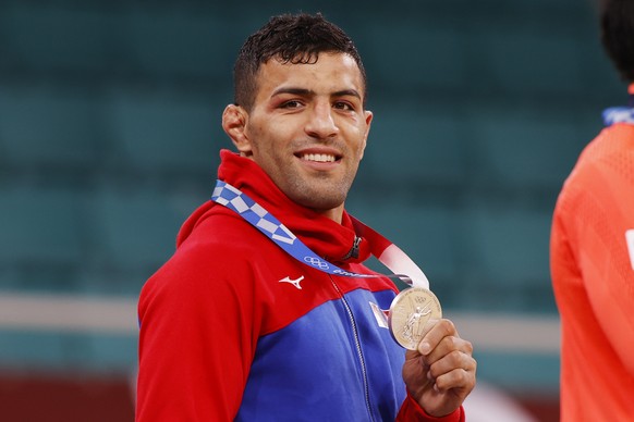 epa09370215 Silver medalist Saeid Mollaei of Mongolia poses during the medal ceremony for the Men&#039;s Judo -81kg category of the Tokyo 2020 Olympic Games at the Nippon Budokan arena in Tokyo, Japan ...