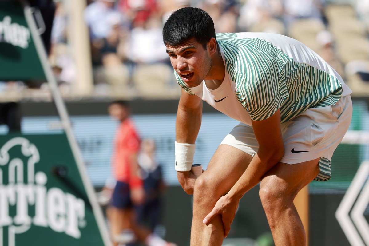 Spain's Carlos Alcaraz reacts with pain at the end of the third game of the third set during his semifinal match of the French Open tennis tournament against Serbia's Novak Djokovic at the R ...