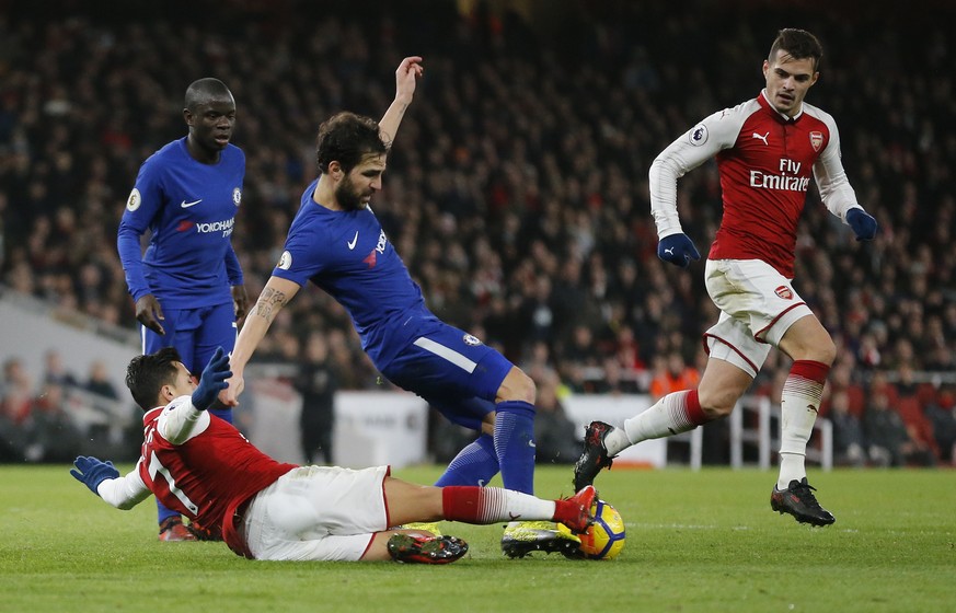Chelsea&#039;s Cesc Fabregas vies for the ball with Arsenal&#039;s Alexis Sanchez during the English Premier League soccer match between Arsenal and Chelsea at Emirates stadium in London, Wednesday, J ...