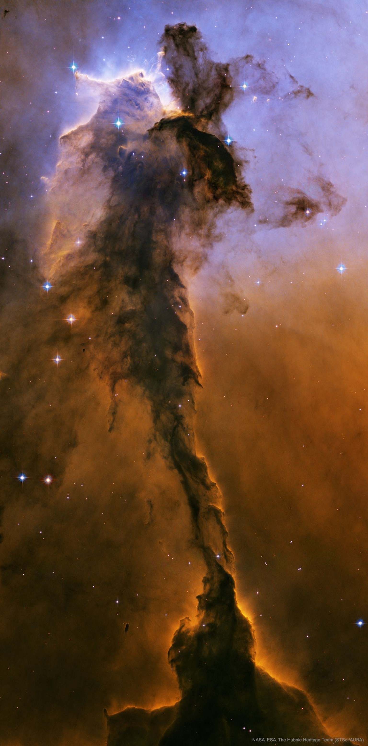 The Fairy of Eagle Nebula 
The dust sculptures of the Eagle Nebula are evaporating. As powerful starlight whittles away these cool cosmic mountains, the statuesque pillars that remain might be imagine ...