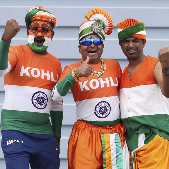 Indian fans cheer as they arrive to watch the ICC Champions Trophy final cricket match between India and New Zealand at Dubai International Cricket Stadium in Dubai, United Arab Emirates, Sunday, Marc ...