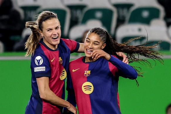 epa11974721 Sydney Schertenleib (R) of Barcelona celebrates with Aitana Bonmati after scoring the 1-4 goal during the UEFA Women's Champions League quarter final soccer match between VfL Wolfsbur ...
