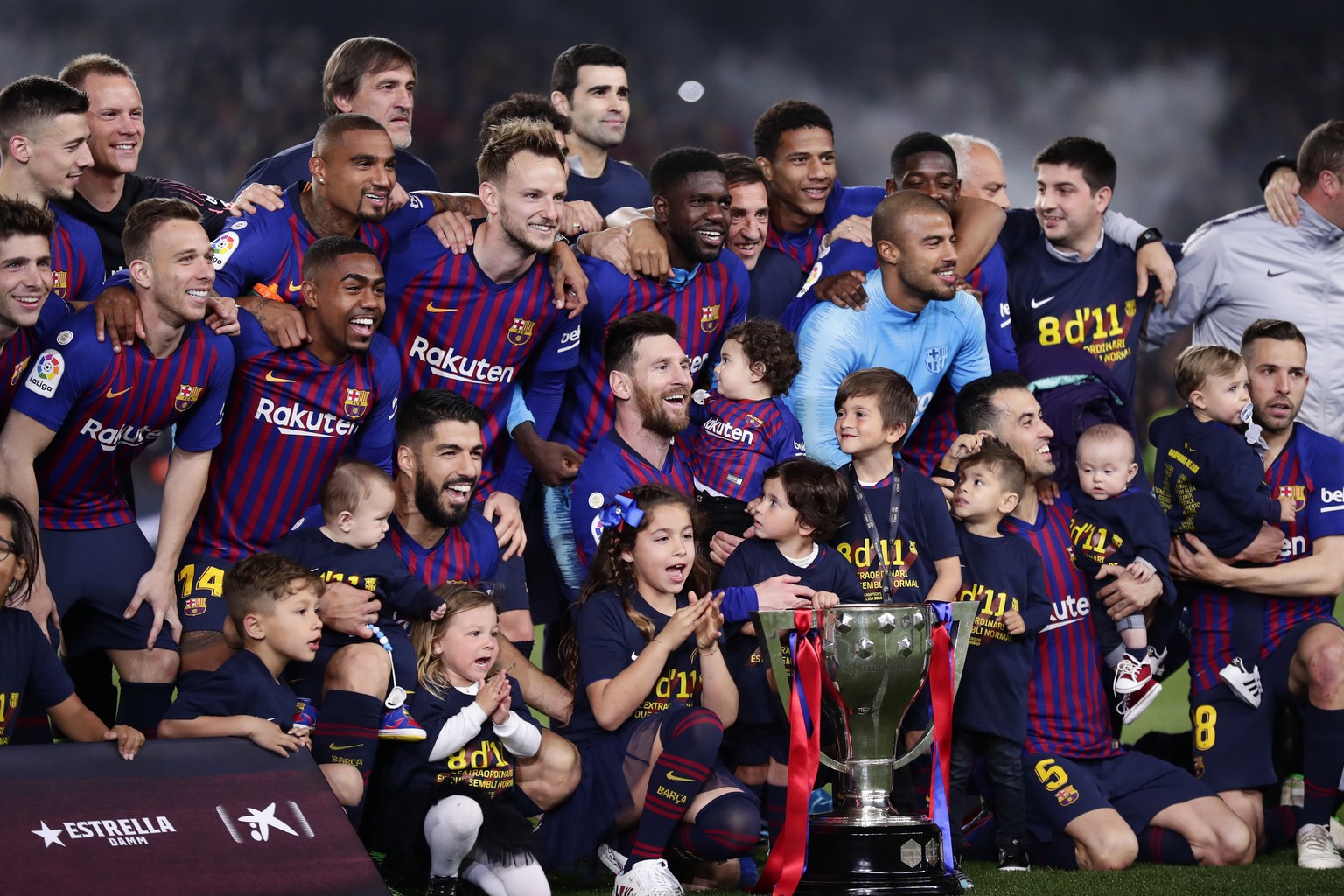 FC Barcelona players, with their children, pose with their trophy after winning the Spanish League title, at the end of the Spanish La Liga soccer match between FC Barcelona and Levante at the Camp No ...