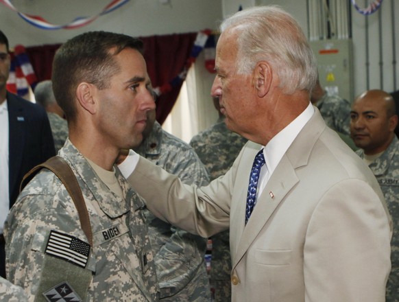 FILE - In the file photo from Saturday, July 4, 2009, U.S. Vice President Joe Biden, right, talks with his son, U.S. Army Capt.  Beau Biden, at Camp Victory on the outskirts of Baghdad, Iraq.  On Saturday, ...