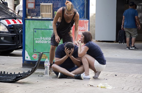 epa06148638 Injured people react after a van crashed into pedestrians in Las Ramblas, downtown Barcelona, Spain, 17 August 2017. According to initial reports a van crashed into a crowd in Barcelona's famous Placa Catalunya square at Las Ramblas area injuring several. Local media report the van driver ran away, metro and train stations were closed. The number of people injured and the reasons behind the incident are not yet known. Official sources have not confirmed that the incident is a terrorist attack.  EPA/David Armengou