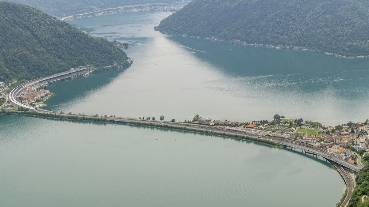 Panoramic aerial view from the top of San Salvatore mountain on Lake Lugano and surroundings, Switzerland xkwx ticino canton swiss forest bridge panoramic panorama view top aerial street road riva san ...