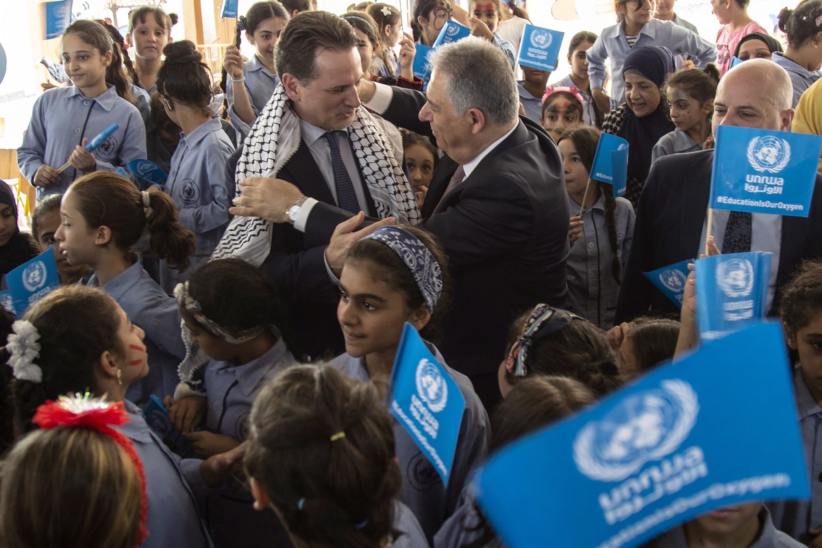 epa07837489 Commissioner-General of the United Nations Relief and Works Agency for Palestine Refugees in the Near East (UNRWA) Pierre Krahenbuhl (C-L) receives a Palestinian 'Koufieh' from P ...