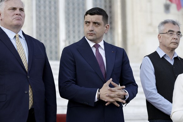 epa12073533 Ultra-nationalist party AUR leader George Simion (C) attends a press conference with foreign media journalists held outside the Parliament Palace, on repeated presidential elections, first ...