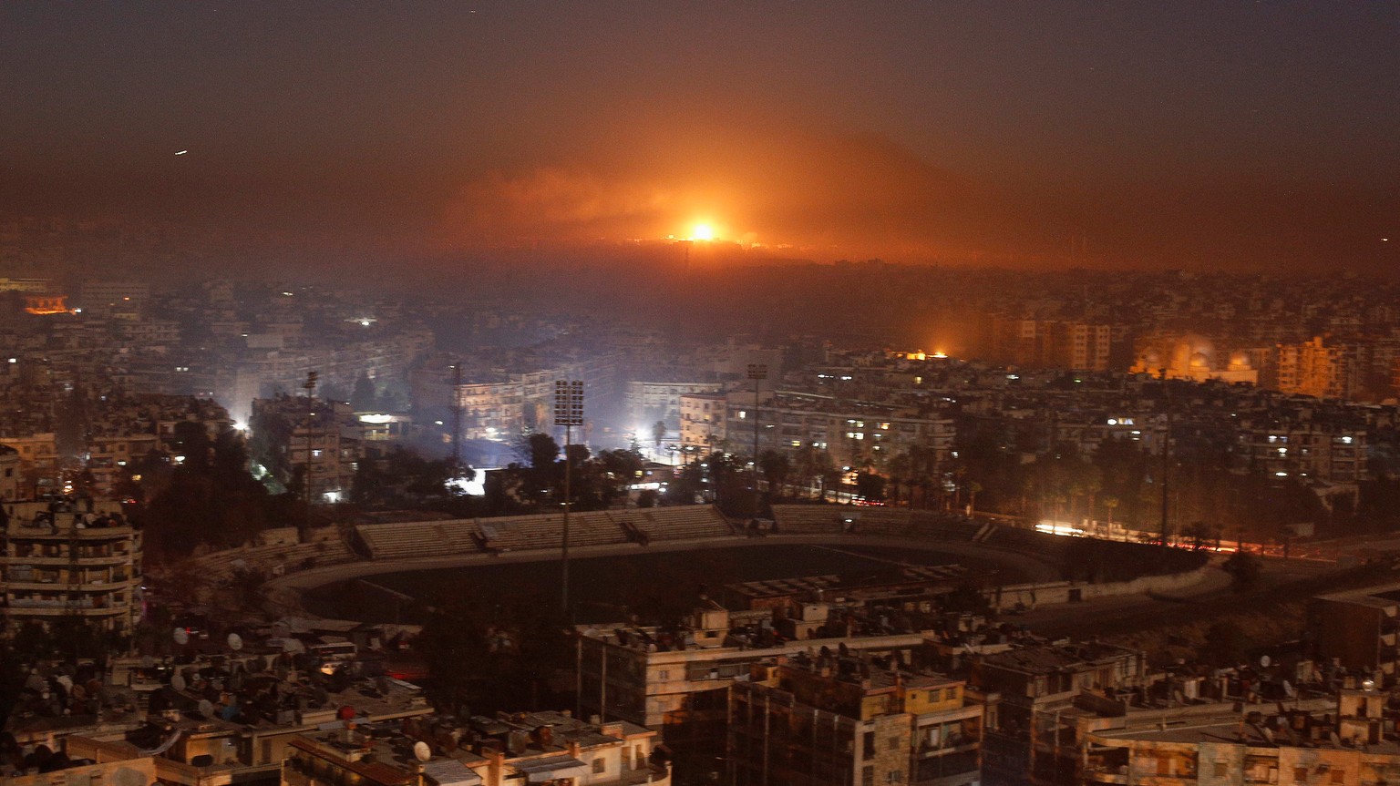 Smoke and flames rise after air strikes on rebel-controlled besieged area of Aleppo, as seen from a government-held side, in Syria December 11, 2016. REUTERS/Omar Sanadiki TPX IMAGES OF THE DAY