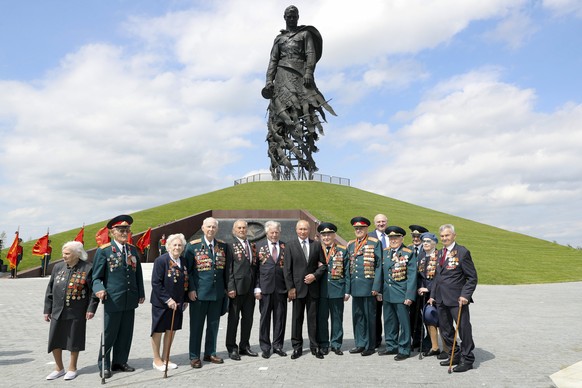 Russian President Vladimir Putin, center right, and Belarusian President Alexander Lukashenko, right in the second row, pose for a photo after an opening ceremony of the monument to World War II Red A ...