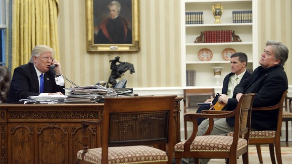 President Donald Trump speaks on the phone with Prime Minister of Australia Malcolm Turnbull, with National Security Adviser Michael Flynn, center, and chief strategist Steve Bannon, right, in the Ova ...