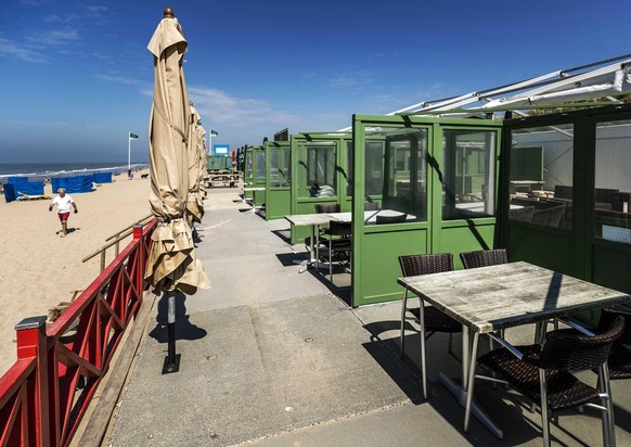 epa08432213 Empty beach pavilions on the Wassenaarse Slag in Wassenaar, The Netherlands, 19 May 2020. From 1 June, food and beverage outlets that had to close due to the corona crisis will be able to  ...