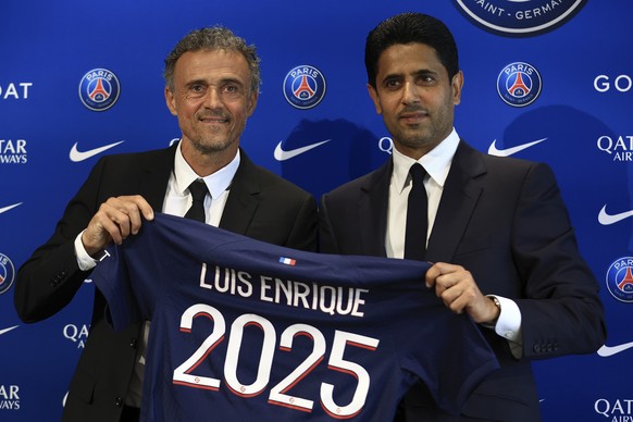 Newly named PSG coach Luis Enrique, left, holds a team jersey with PSG president Nasser Al-Khelaifi during a press conference at the new Paris-Saint-Germain training ground Wednesday, July 5, 2023 in  ...