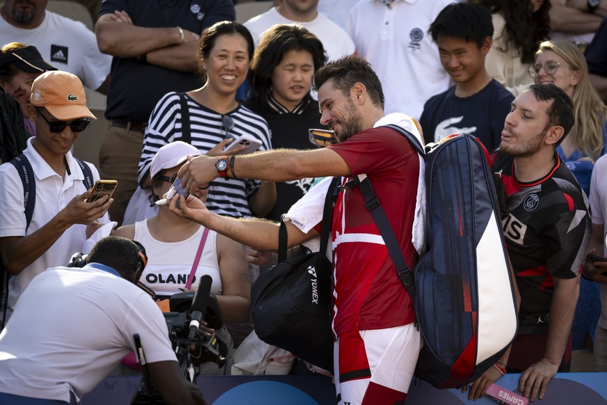 Stanislas Wawrinka of Switzerland takes a selfie with spectators after his victory against Pavel Kotov of Russia (not pictured) during the men&#039;s single first round tennis match at the 2024 Paris  ...