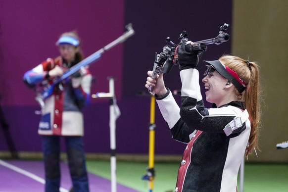 Nina Christen, right, of Switzerland, reacts after the last shot in the women&#039;s 50-meter 3 positions rifle at the Asaka Shooting Range in the 2020 Summer Olympics, Saturday, July 31, 2021, in Tok ...