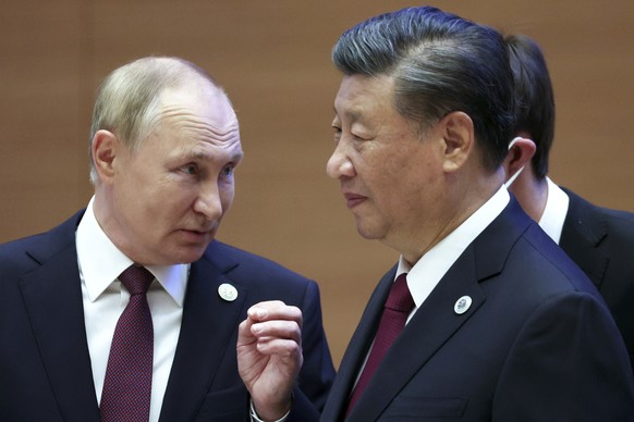 FILE - Russian President Vladimir Putin, left, gestures while speaking to Chinese President Xi Jinping during the Shanghai Cooperation Organization (SCO) summit in Samarkand, Uzbekistan, Sept. 16, 202 ...