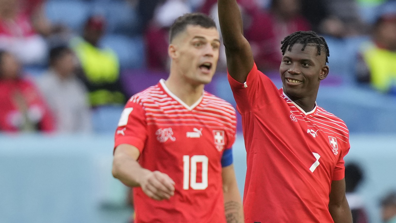 Switzerland's Breel Embolo, right, celebrates after scoring his side's opening goal during the World Cup group G soccer match between Switzerland and Cameroon, at the Al Janoub Stadium in Al Wakrah, Q ...