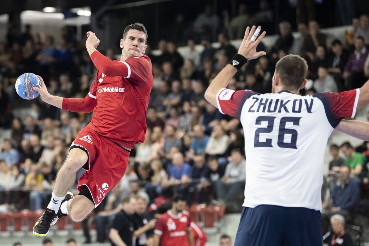 Switzerland's Andy Schmid, left, in action against Ukraine's Stanislav Zhukov, right, during the Yellow Cup Handball game between Switzerland and Ukraine in Switzerland, Winterthur, Friday 0 ...