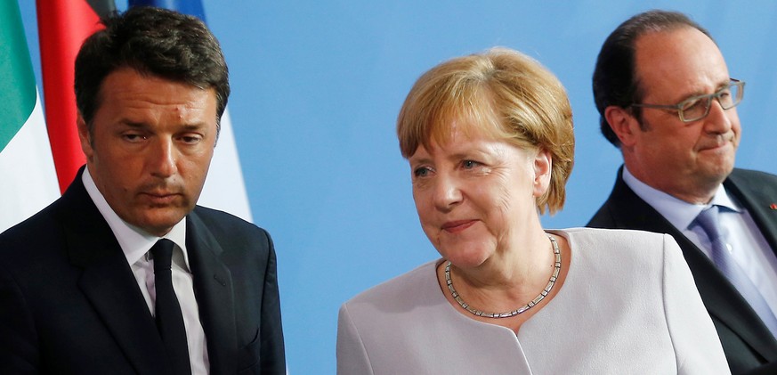 German Chancellor Angela Merkel (C), French President Francois Hollande (R) and Italian Prime Minister Matteo Renzi attend a news conference at the chancellery during discussions on the outcome of the ...