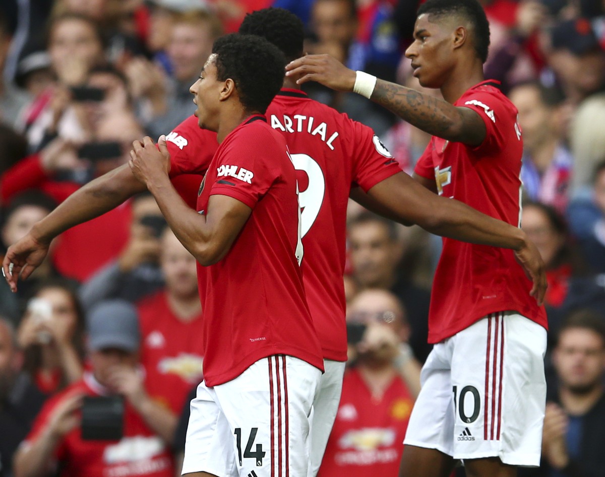 Manchester United's Marcus Rashford, right, celebrates with teammates after scoring his sides first goal during the English Premier League soccer match between Manchester United and Chelsea at Ol ...