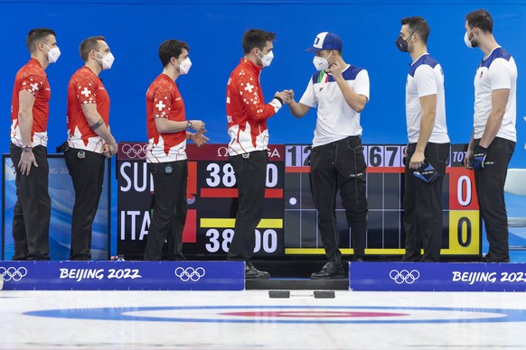 Players of Italy team and Switzerland team greet each prior the men's Round Robin #7 game between Switzerland and Italy at the National Aquatics Centre at the 2022 Olympic Winter Games in Beijing, China, on Sunday, February 13, 2022. (KEYSTONE/Salvatore Di Nolfi)