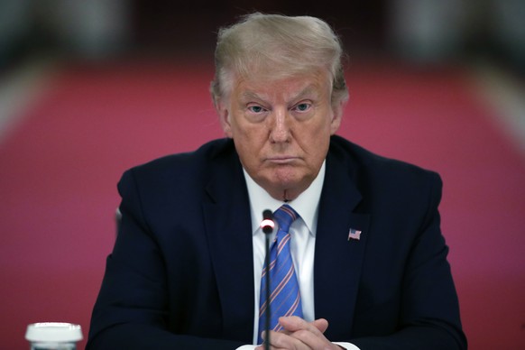 FILE - President Donald Trump listens during a &quot;National Dialogue on Safely Reopening America&#039;s Schools,&quot; event in the East Room of the White House, on July 7, 2020, in Washington. A fe ...