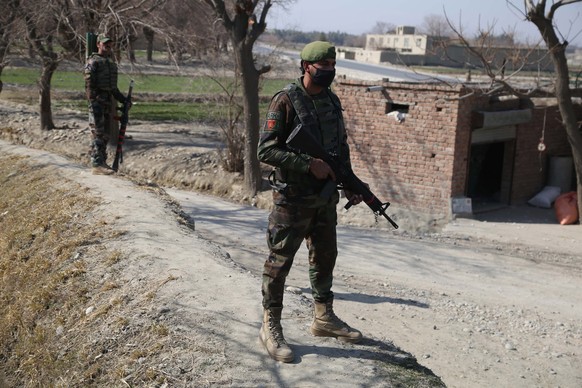 epa08204982 Afghan Army soldiers stand guard at a check point near the Shirzad district, in Hogyani district of Nangarhar province, Afghanistan, 09 February 2020. At least two American soldiers were k ...