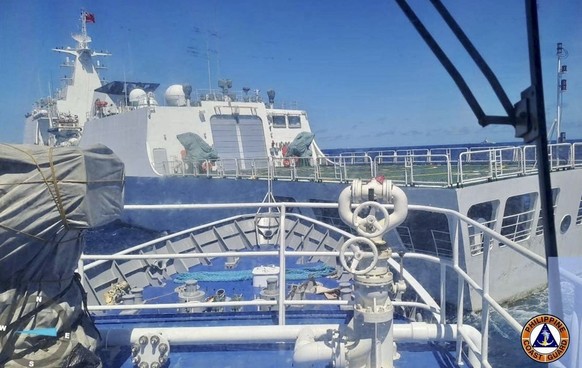In this photo provided by the Philippine Coast Guard, a Chinese Coastguard ship, front, allegedly blocks the path of a Philippine Coast Guard ship near the Philippine-occupied Second Thomas Shoal, Sou ...