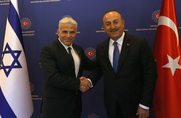 epa10029727 Turkish Foreign Minister Mevlut Cavusoglu (R) welcomes Israeli Foreign Minister Yair Lapid (L) in Ankara, Turkey, 23 June 2022. Lapid is visiting Turkey for talks that are expected to focu ...