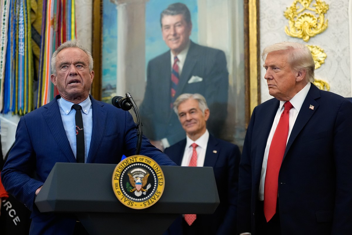 President Donald Trump listens as Health and Human Services Secretary Robert F. Kennedy Jr., speaks in the Oval Office of the White House, Thursday, Oct. 16, 2025, in Washington. (AP Photo/Alex Brando ...