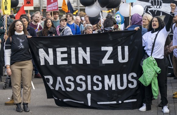 Menschen demonstrieren an einer von der Sans-Papiers-Kollektive und der Anlaufstelle fuer Sans-Papiers Basel organisierten Kundgebung mit dem Motto Nein zu Rassismus! Ja zur Regularisierung! in Basel, ...