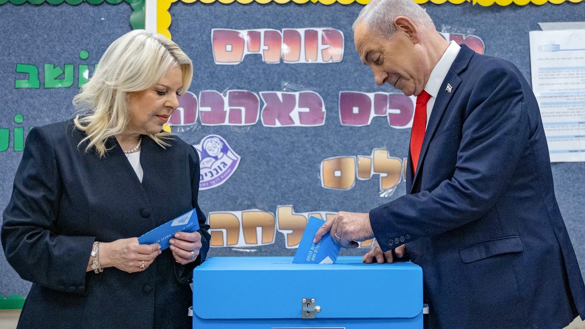 Israel's Prime Minister Benjamin Netanyahu casts his ballot, alongside his wife Sara, at a polling station in Jerusalem, Tuesday, Oct. 27, 2026. (Yonatan Sindel/Pool Photo via AP) CORRECTION: Age ...