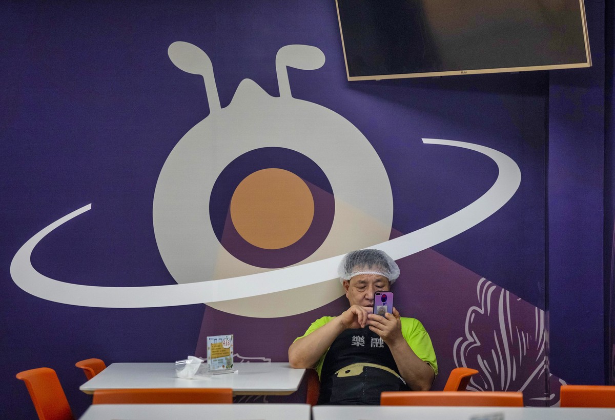 epa08702969 A man rests in the Ant Group headquarters canteen in Hangzhou, China, 27 September 2020 (issued 28 September 2020). Ant Group is the parent company of China's largest mobile payments  ...