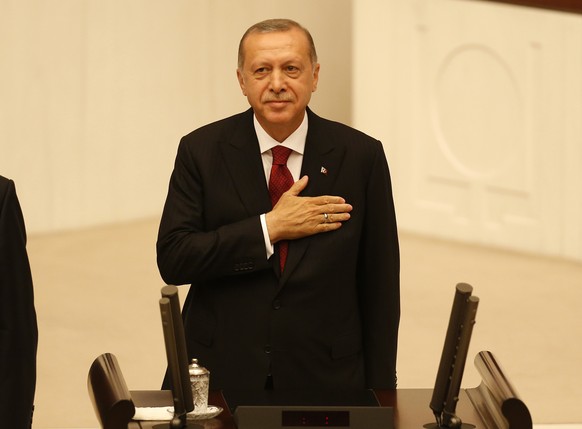 Turkey&#039;s President Recep Tayyip Erdogan greets supporters at the parliament in Ankara, Turkey, Monday, July 9, 2018 when taking the oath of office for his second term as president. (AP Photo/Left ...